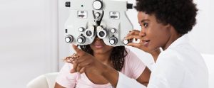 eye doctor giving eye exam to patient
