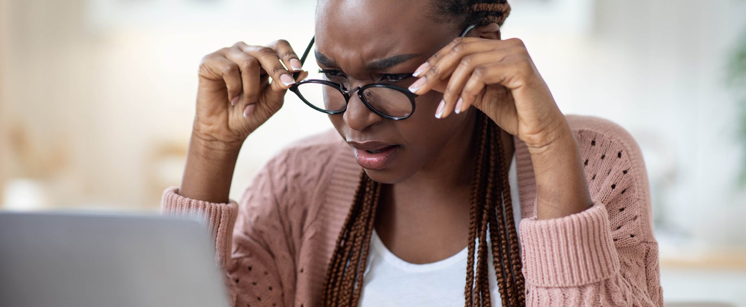 woman adjusting glasses